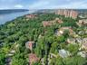 Aerial view of property and surrounding area with a nearby body of water