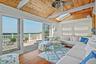 Interior living space with vaulted wood-plank ceiling, skylights, and ceiling fan