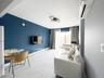 Living area with a wall of windows, a baseboard radiator, and light marble finish flooring