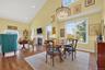 Dining space featuring high vaulted ceiling, wood-type flooring, recessed lighting, and a fireplace