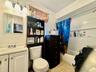 3 - Full bath with shower / bath combination with curtain,  tile patterned floors, vanity, and toilet