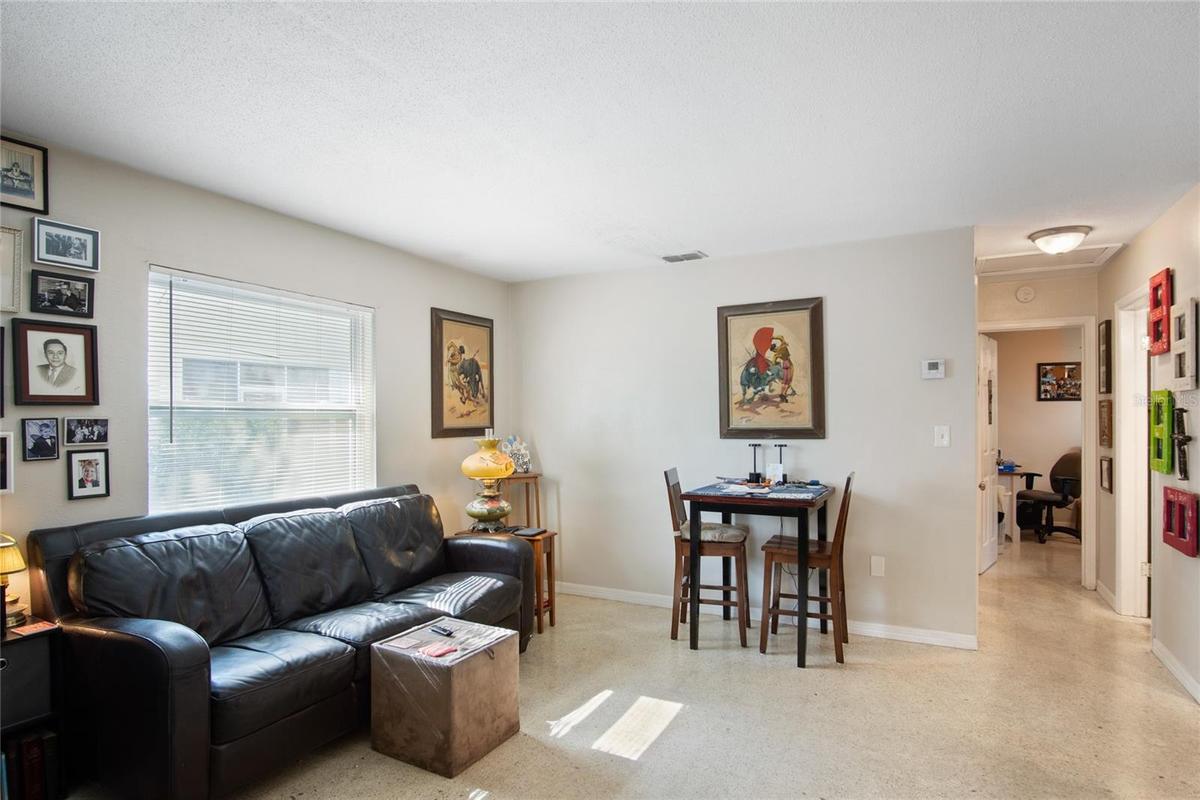 A view of the living and dining area that looks down the hall to the bedrooms.