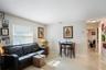 A view of the living and dining area that looks down the hall to the bedrooms.