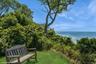 View of community with a water view and a lawn