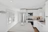 Kitchen with modern cabinets, stainless steel appliances, dark wood finished floors, decorative backsplash, and white cabinetry