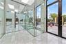 Stairway featuring expansive windows, french doors, and marble finish flooring