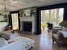 living room with sunfilled den in background