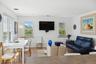Living area featuring light wood finished floors, baseboards, visible vents, and recessed lighting