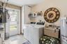 Washer & dryer in the garage with a laundry sink with newer faucet and new water heater.