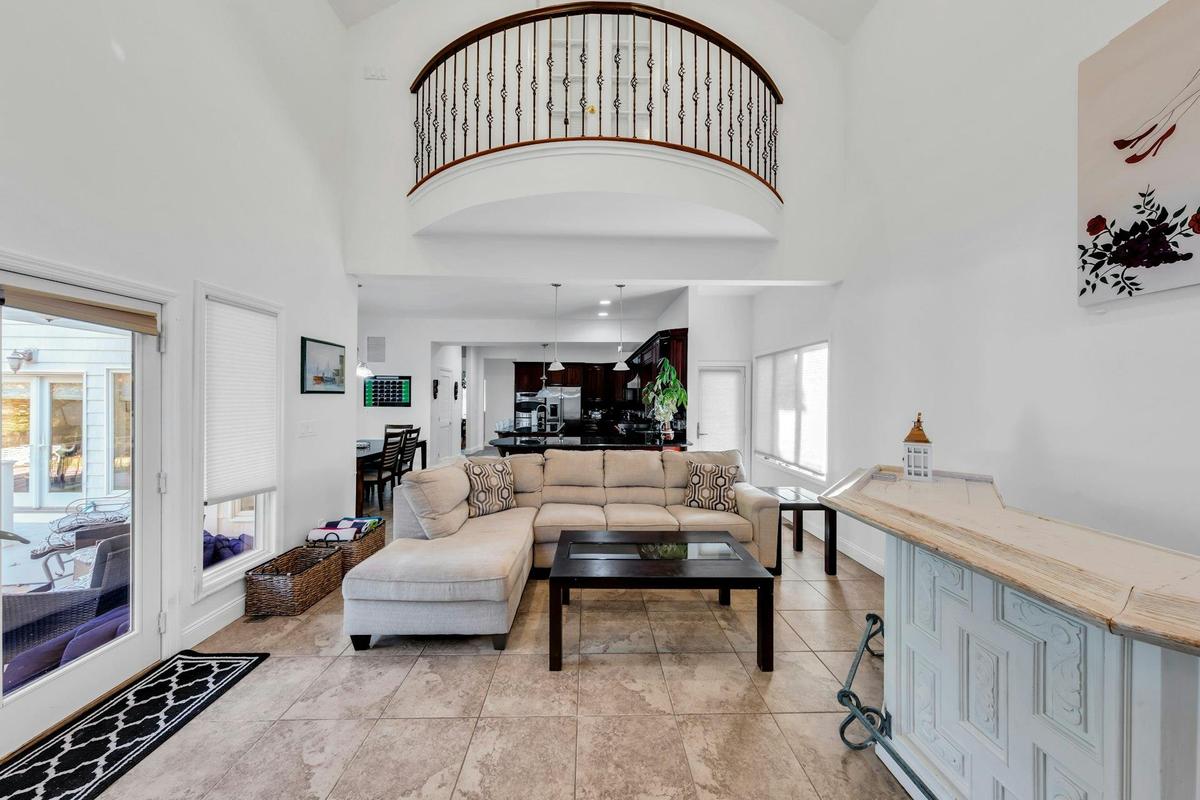 Living area featuring a towering ceiling and light tile patterned floors