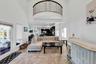 Living area featuring a towering ceiling and light tile patterned floors