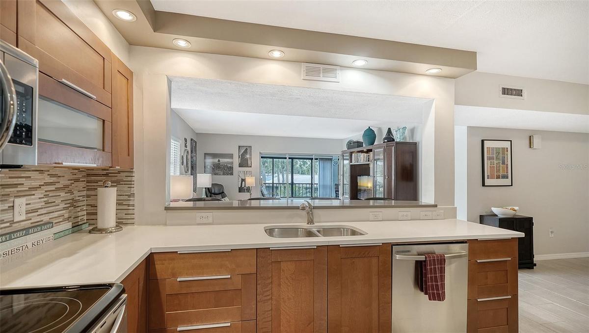 Open kitchen looks into the living room and beyond into the lanai.