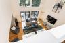 Living room with light wood finished floors and a high ceiling