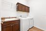 Large laundry room with built-in sink and cabinetry.