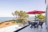 Balcony featuring outdoor dining space and a water view