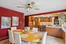 Dining room with light tile patterned flooring, a ceiling fan, and crown molding
