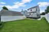 Backyard along with wooden deck.