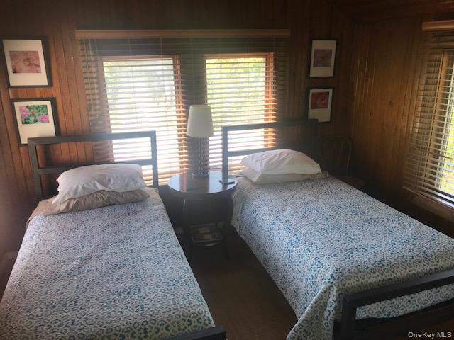 Bedroom with wooden walls