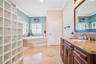 Primary Bathroom with dual granite vanities, Spacious Walk-In Shower with 7 heads and detachable hose and a large, separate tub