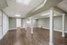 Finished basement with wood-finish flooring, recessed lighting, and drop ceiling
