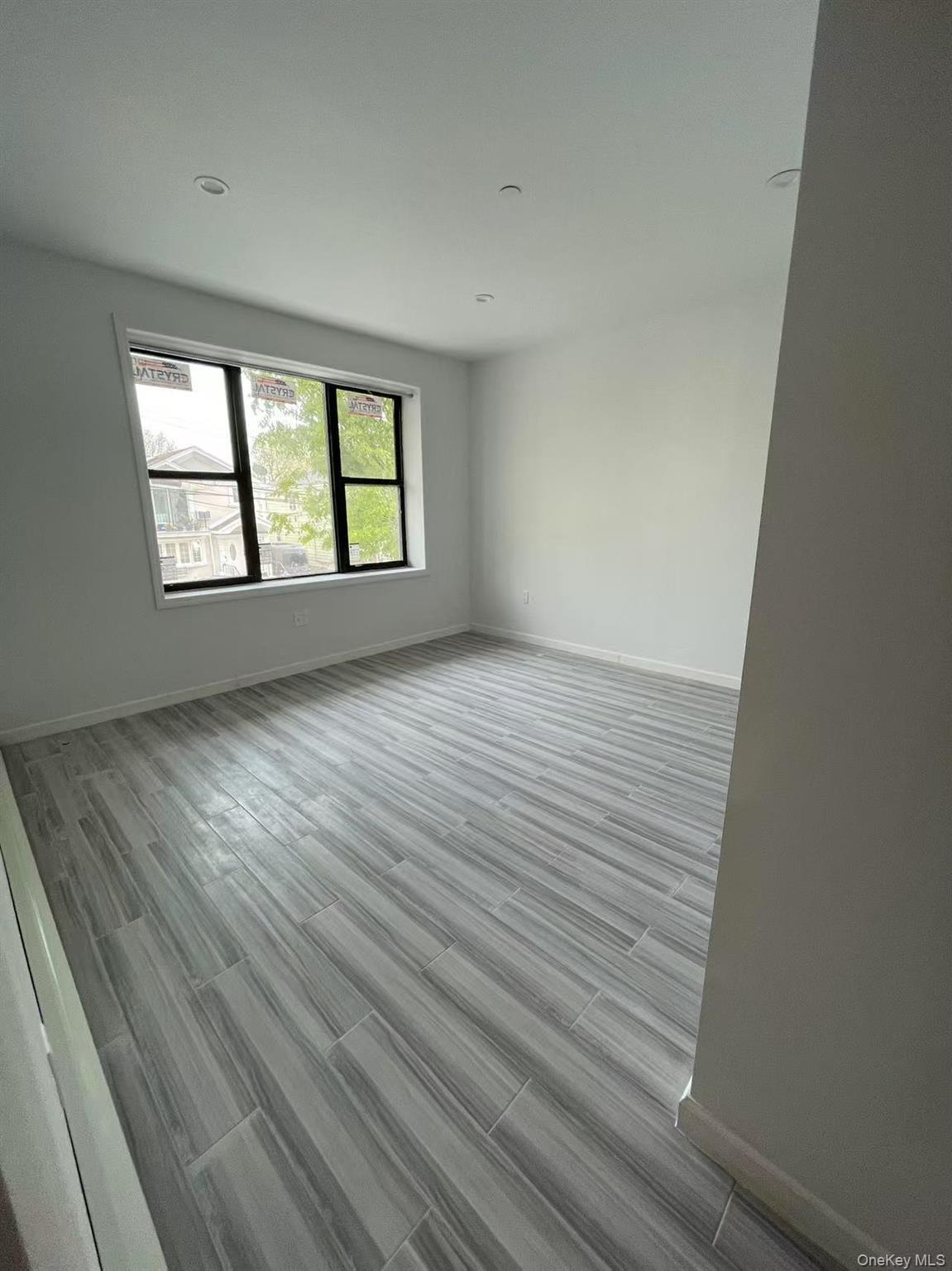 Empty room featuring baseboards and wood finished floors