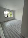 Empty room featuring baseboards and wood finished floors