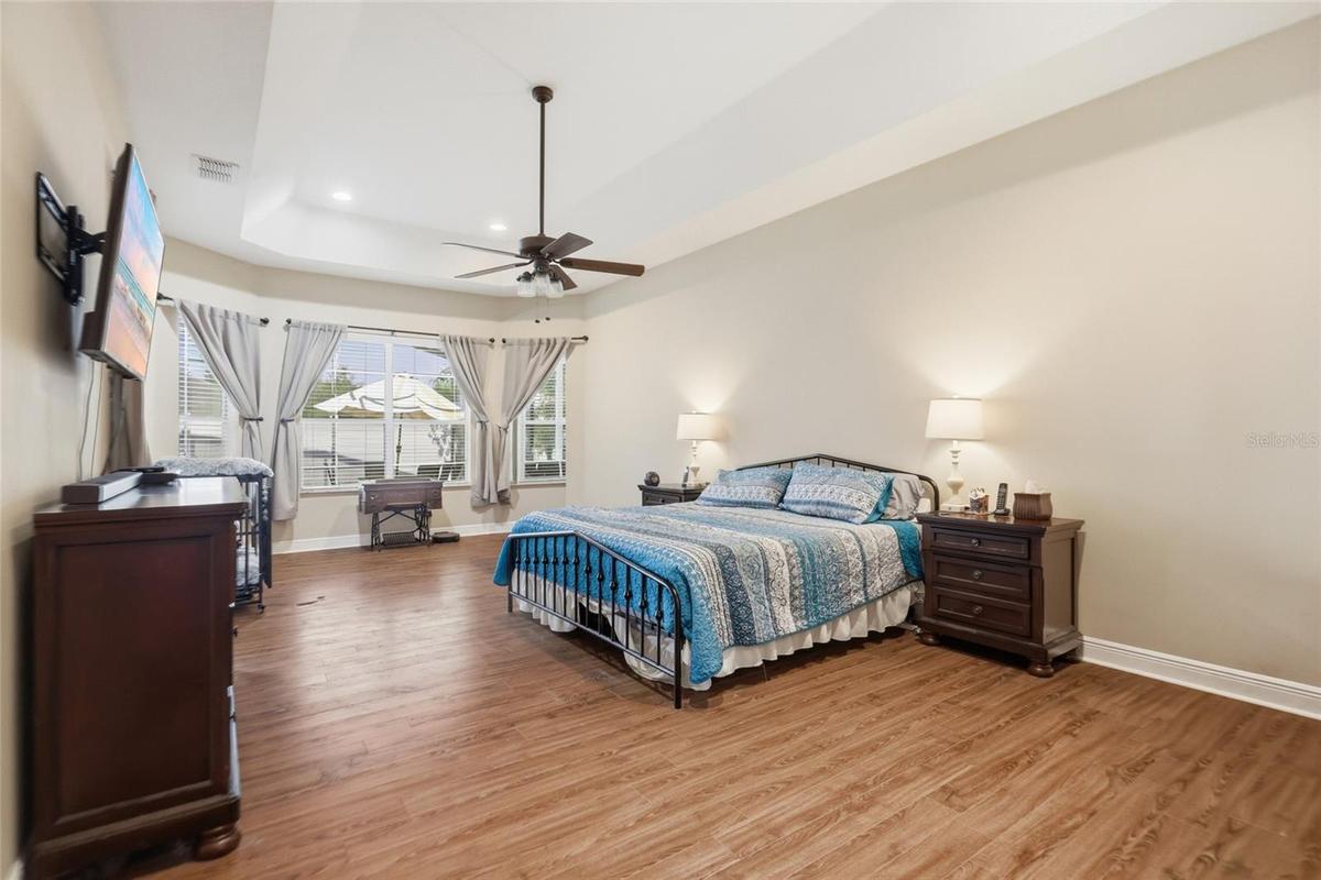 Private primary suite with large picturesque windows allowing a view of the backyard