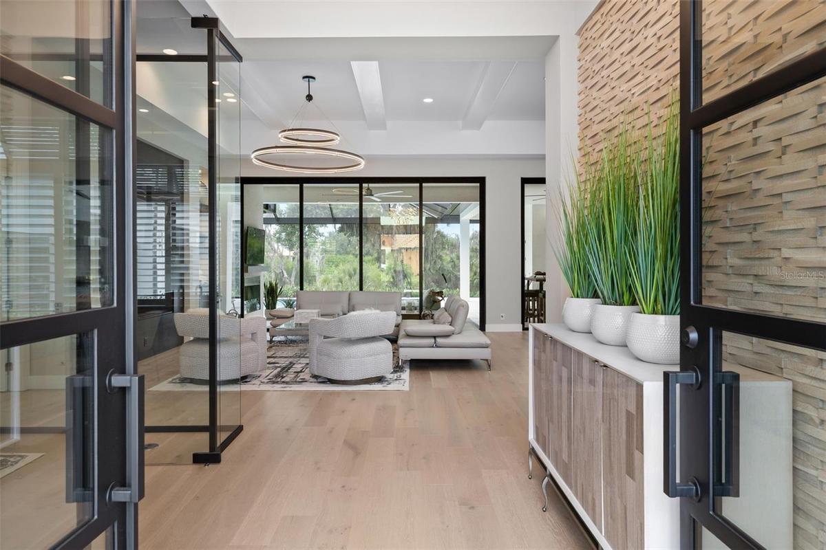 Inside, rich wood flooring flows seamlessly throughout.