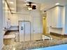 Granite kitchen counters, white cabinets & pantry.