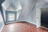 Room featuring sloped ceilings and wood-finish flooring