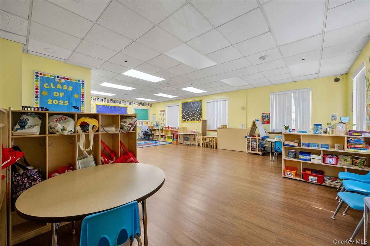 Rec room featuring a drop ceiling and wood finished floors