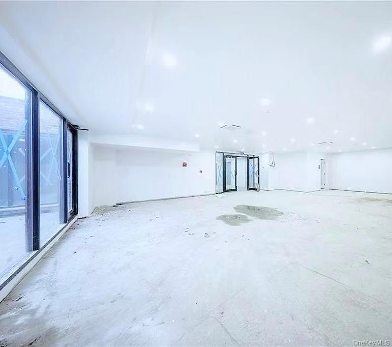 Unfurnished room featuring unfinished concrete floors