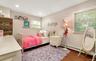 Bedroom featuring wood finished floors, a baseboard heating unit, and recessed lighting