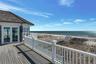 Deck featuring view of the ocean and beach