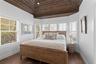 Bedroom with baseboards and wood finished floors