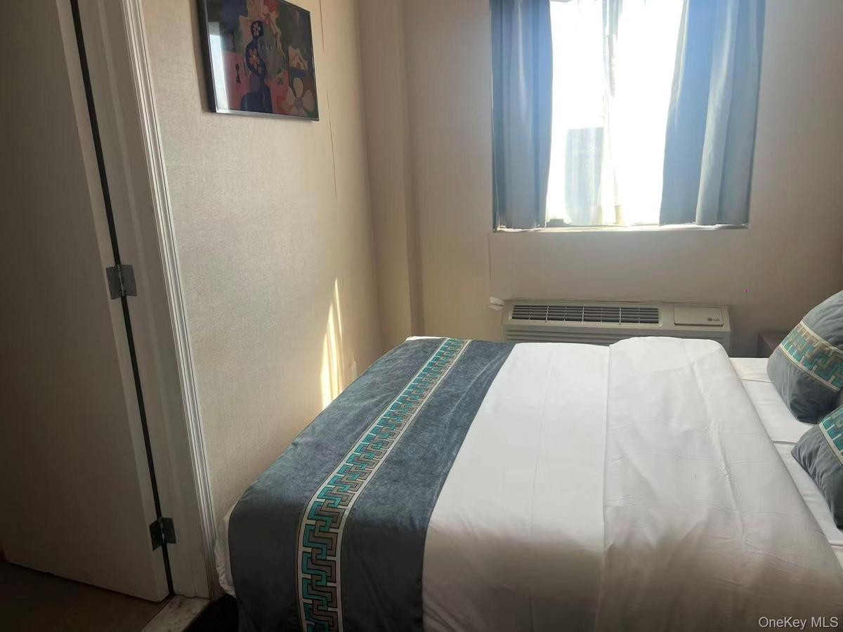 Bedroom featuring a wall mounted air conditioner