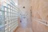 Primary Bathroom with dual granite vanities, Spacious Walk-In Shower with 7 heads and detachable hose and a large, separate tub