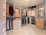 Brand new closet shelving. Virtually staged w/ clothing, hamper & mirror.