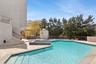 View of swimming pool featuring a pool with connected hot tub, a pergola, a wooden deck, and outdoor dining space