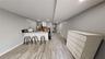 Kitchen featuring white cabinetry, a baseboard radiator, a kitchen breakfast bar, light hardwood / wood-style floors, and kitchen peninsula