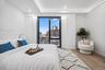 Bedroom with light wood-style flooring, baseboards, a city view, and recessed lighting