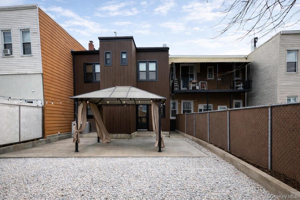 Rear view of house with a gazebo and a patio area