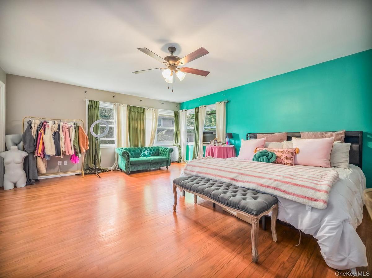 Bedroom with wood finished floors and ceiling fan