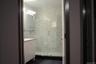Bathroom with a shower stall, vanity, and dark tile patterned flooring