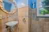 Bathroom with a sink and tile walls