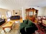Living room featuring visible vents, stairs, wood finished floors, and wooden ceiling