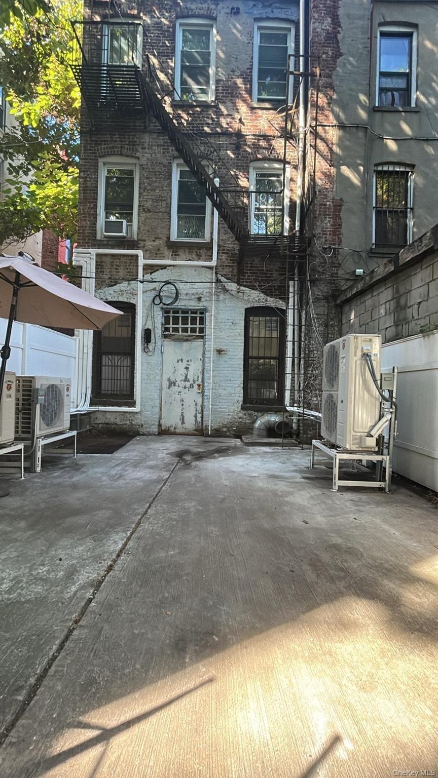 Rear view of property featuring brick siding