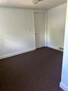 Carpeted spare room with a baseboard radiator
