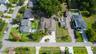 Front aerial perspective highlighting curb appeal and spacious property.