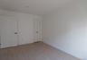 Spare room featuring light wood finished floors and baseboards